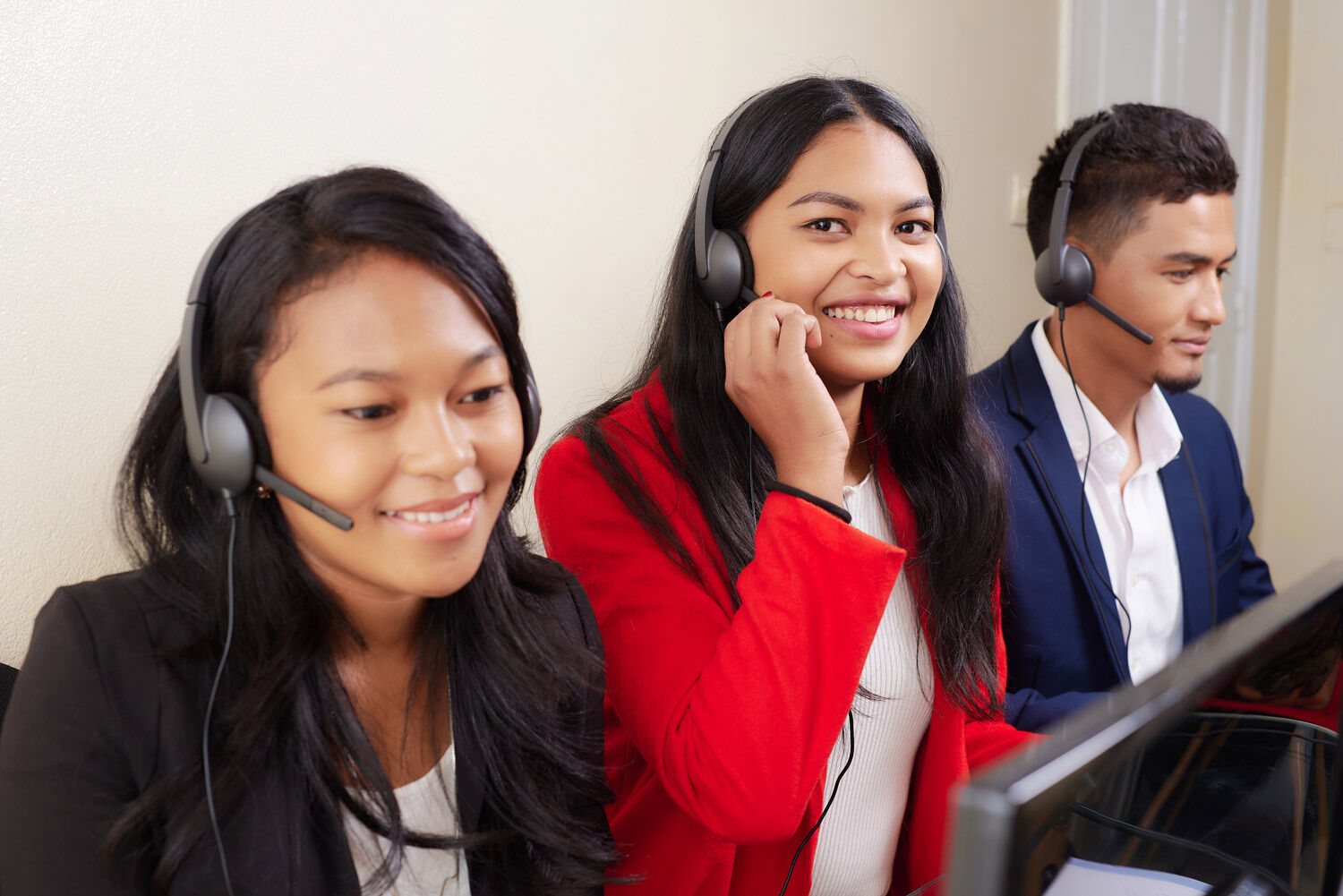 Téléconseillers DIALOPRO souriants en production, casque sur les oreilles